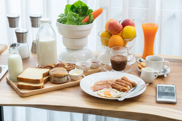 The continental breakfast table with black coffee, milk, bread , salad, fruit and juice. The chili sauce and ketchup to enhance the flavor.
