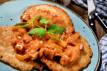 Homemade potato pancakes with goulash.