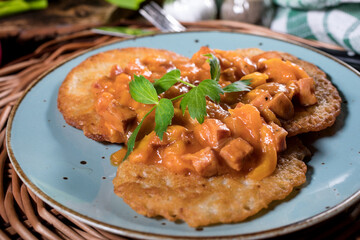 Homemade potato pancakes with goulash.