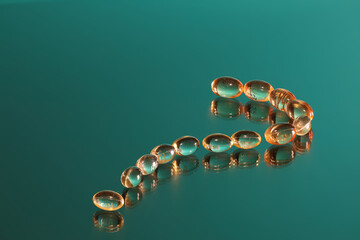 Prescriptions drugs in the form of a question mark on a green background