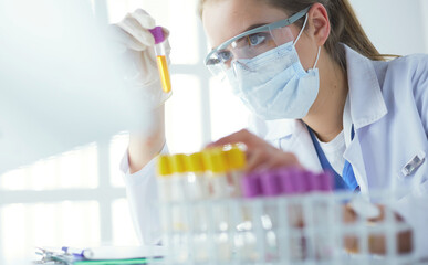 Researcher, doctor, scientist or laboratory assistant working with plastic medical tubes in modern...