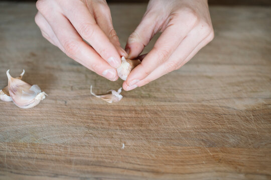 Person peeling garlic