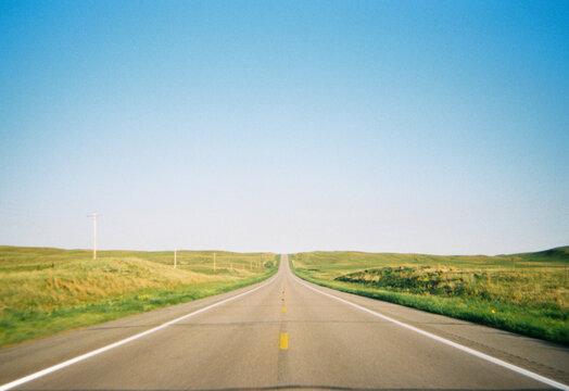 Road in middle of flat landscape countryside