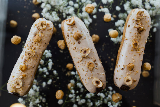 Hazelnut eclairs on a black background