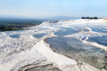 Panoramic view onto travertine terraces of Pamukkale, Turkey. All pools filled with mineral water from natural spring. Site is very attractive for tourists. Reserve included in UNESCO List