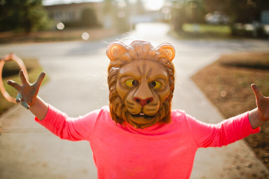 little girl in lion mask