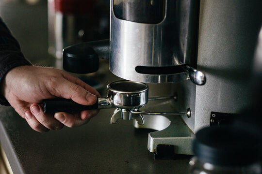 Barista using coffee grinder