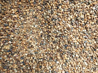 Pebbles of different shapes, sizes, and colors. Small boulders on the beach or decorate your home garden.Outdoor background design
