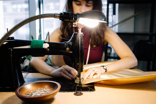 Woman sewing gold skirt