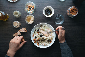 Healthy rice with tuna, almonds and black olives