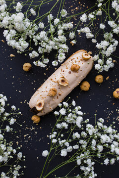 Hazelnut eclair on a black background