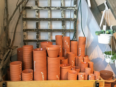 Stacks of terracotta flower pots stacked on a cart