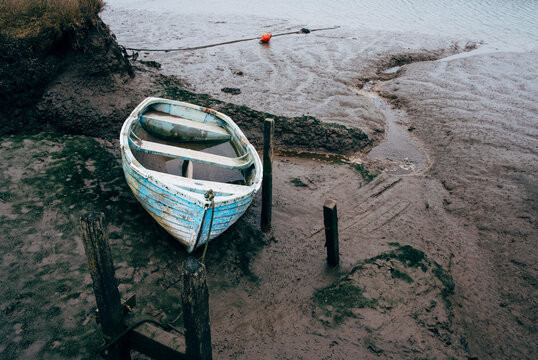 Old rowing boat on the mud flats at Morston Quay, Norfolk, UK.