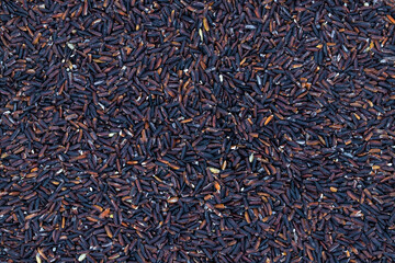 Black rice flat lay. Cereal photo texture. Diet healthy food ingredient. Black rice scatter top view for package design background. Organic grain. Forbidden rice superfood banner template