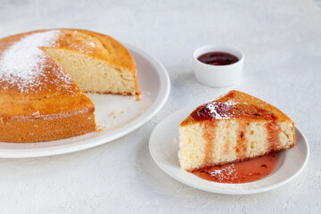 Homemade biscuit pie and piece of cake with jam on plate