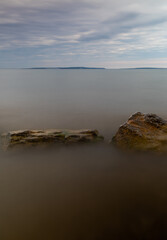 Cloudy Lake Huron and beach in the morning in summer Michigan. Long exposure