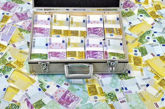 Case full of euro banknotes on money background. Counterfeit euro notes. Business concept and undeclared cash