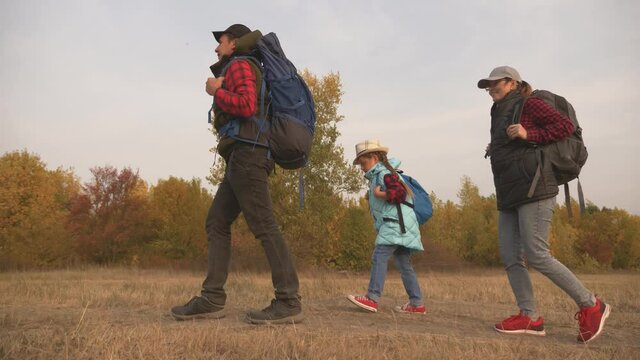Tourists teamwork concept in hiking travel. Friendly family mom dad and daughter are hiking outdoors. Family vacation happy friendly family lifestyle. The child spends time with his parents.