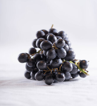 Black grapes on a white background.