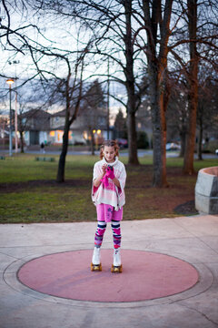 Preteen girl on roller skates using smartphone