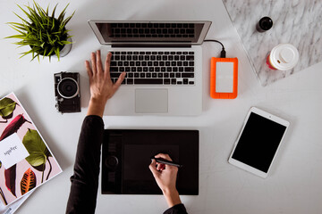 Professional female retoucher working from over head