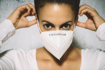 Portrait of young european woman wearing a mask