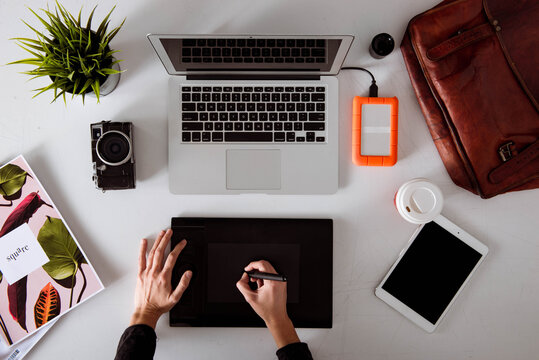 Professional female retoucher working from over head