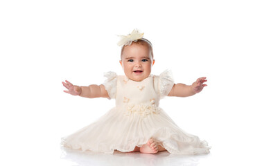 Portrait of a happy baby girl in festive clothes on a white background.