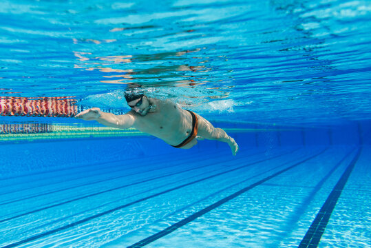 Caucasian man swimming crawl in the pool