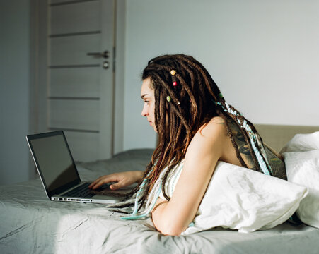 Woman working on her laptop from home