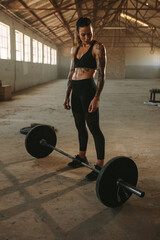 Muscular female athlete at crossfit training gym