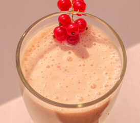 Milky pink cocktail and red currant berries