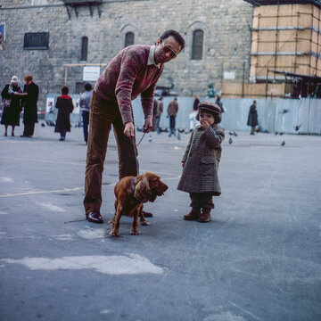 1981. Dad and son with their dog posing for a photo.