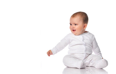 Intrigued baby in a white bodysuit looks to the side on a white background.