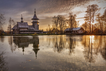 Wooden orthodox church of the Annunciation and its reflection in the lake on an autumn day. Moscow region, Sergiyev Posad district. The Blagovescheniye village