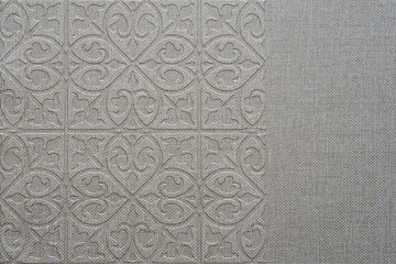 Ornamental print on a rough gray texture. Close-up of gray seamless texture. Wallpaper. Burlap texture. Pattern on linen fabric