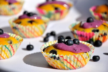 Blueberry muffins on a white table.