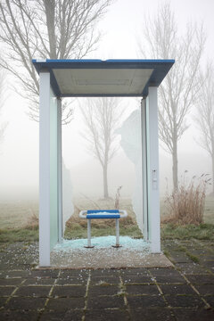 Rural busstop with smashed glass wall