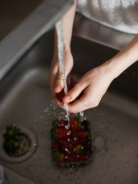 Woman washing berries