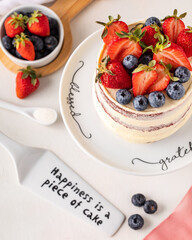 Red Velvet cake, viewed  from the top, fruits, and decorations.