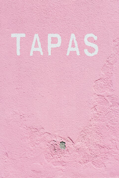 The Word Tapas Written on a Pink Wall