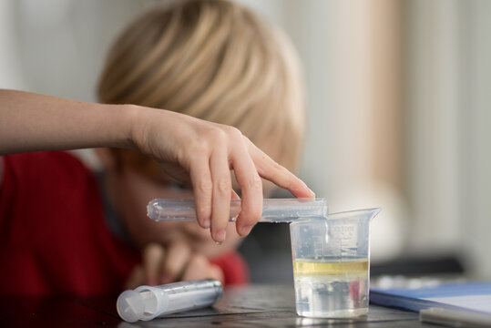 Child Scientist Mixing Chemicals with Chemistry Set for Science Education