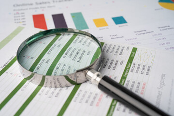 Magnifying glass on charts graphs paper. Financial development, Banking Account, Statistics, Investment Analytic research data economy, Stock exchange trading, Business office company meeting concept.