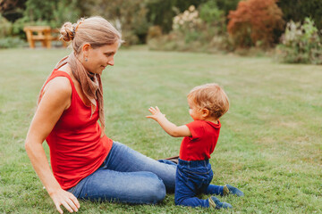 Fototapeta premium Mother with 12 months old baby in garden