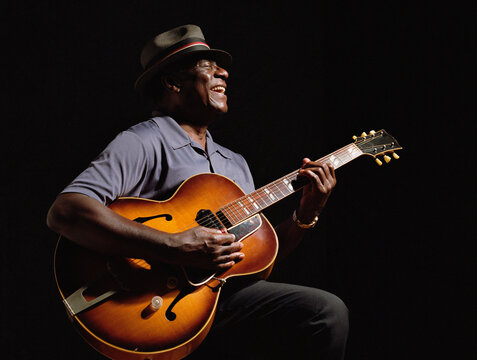 African American man playing guitar