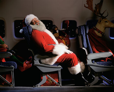 Santa Clause, reindeer and presents on an airplane