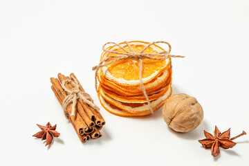 Creative, Christmas and new year, winter composition. dried orange slices tied with string, walnuts, star anise and cinnamon sticks on a white background. copy space. selective focus