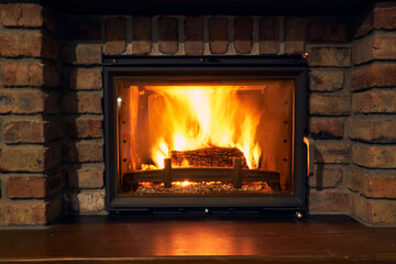 fireplace and fire close view as object or background, brick wall