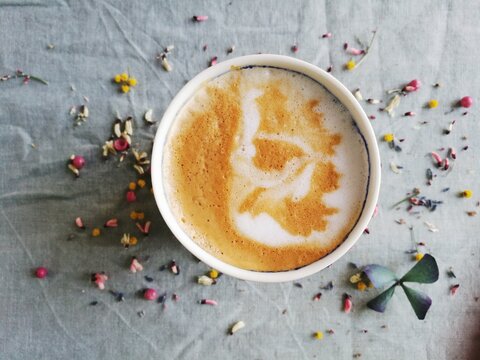Homemade cappucino coffee with floral background