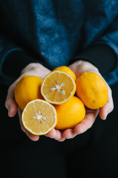 Holding fresh organic lemon